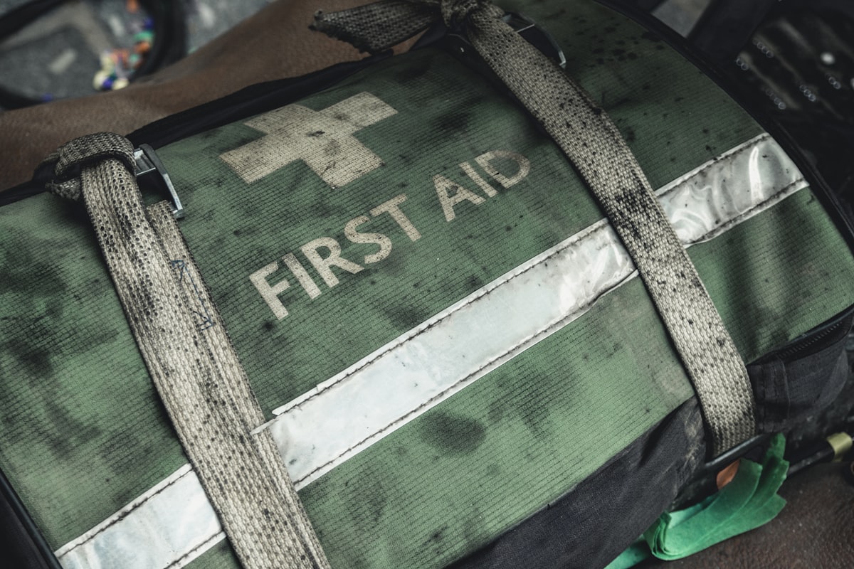 green and black first aid bag